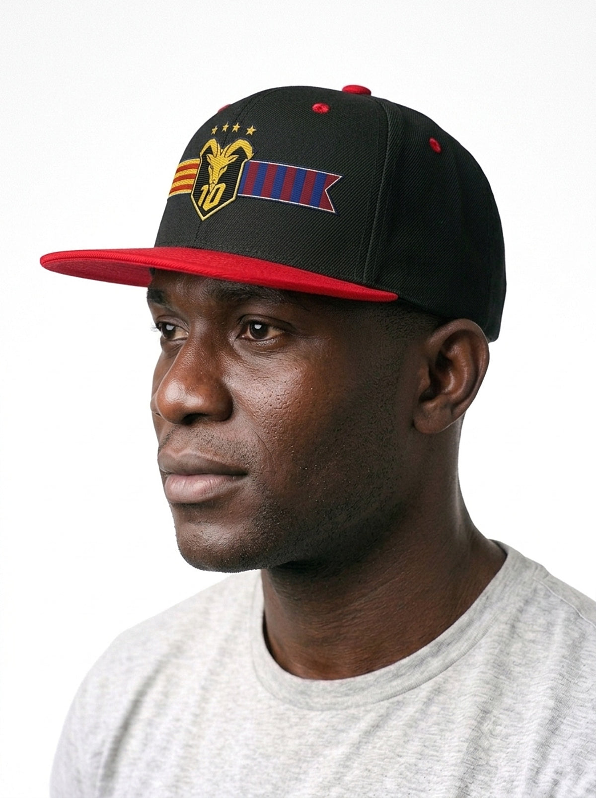 GOAT Catalan two-tone snapback in Oji Black / Uhie Red, three-quarter left view — structured crown and flat brim.
