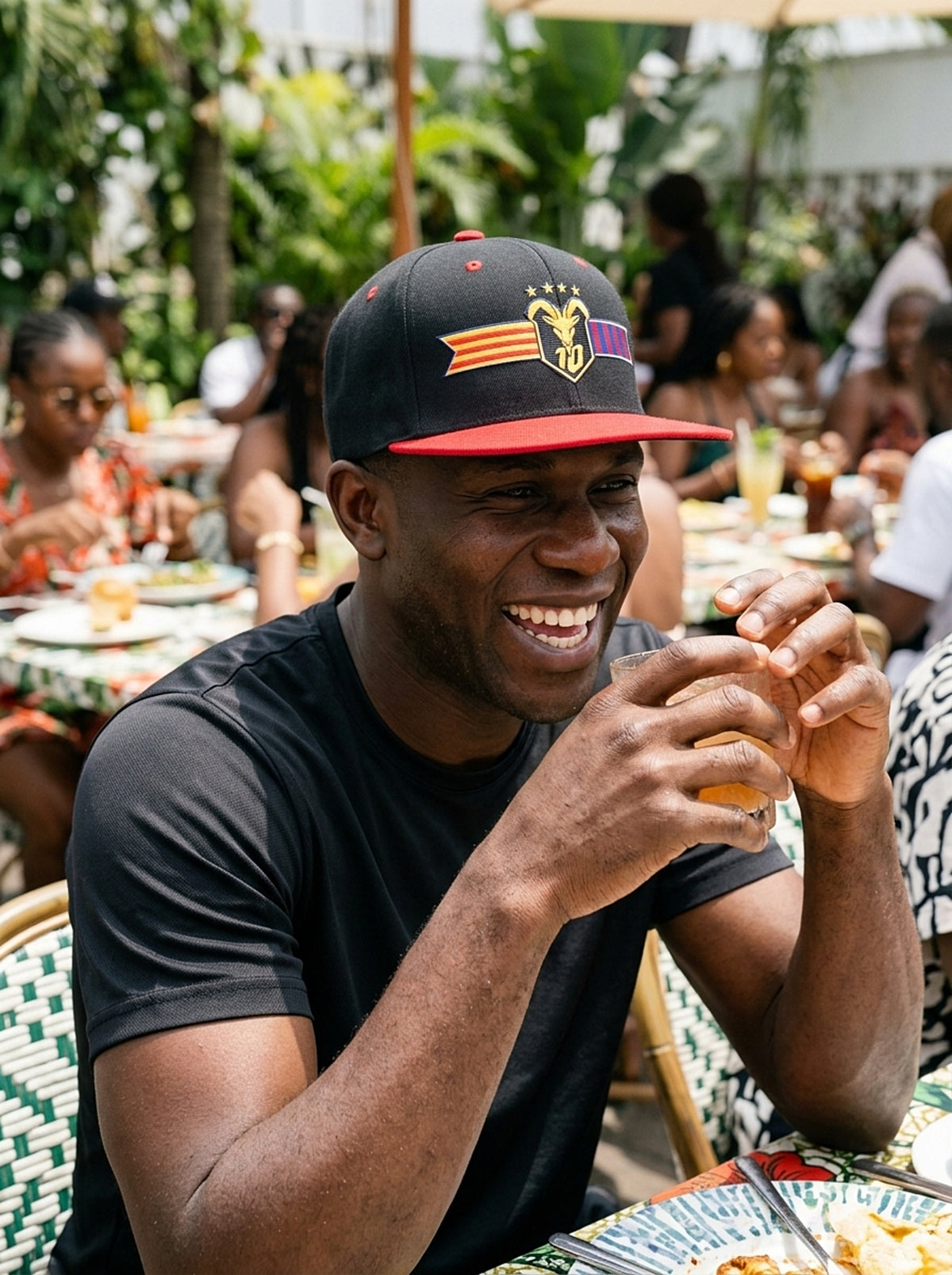 Lifestyle action shot of the GOAT Catalan two-tone snapback in Oji Black / Uhie Red.