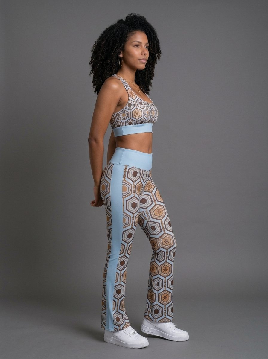 Three-quarter right view of the Igwe Blue AnanseNova™ Set, hexagon-print longline sports bra and flare leggings on AsaseFlex™ stretch