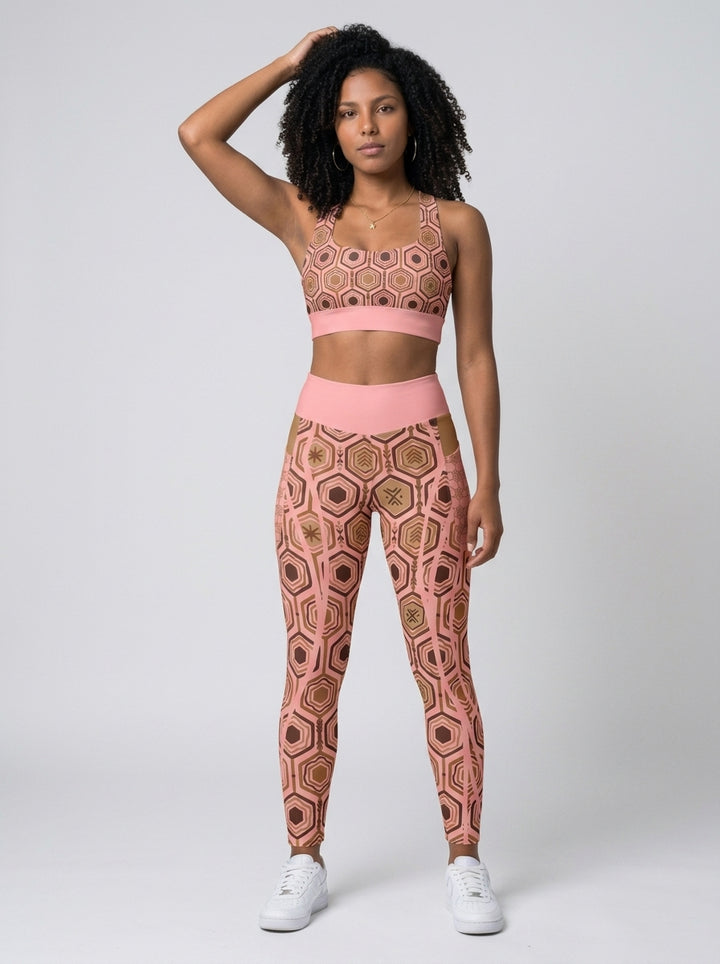 AnanseNova™ Set // Bra + Pocket Leggings in Adaeze Pink — front view on model, hexagon-print longline sports bra and high-waisted side-pocket leggings