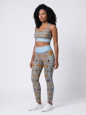 AnanseNova™ Set // Bra + Pocket Leggings in Igwe Blue — front view on model, hexagon-print longline sports bra and high-waisted side-pocket leggings