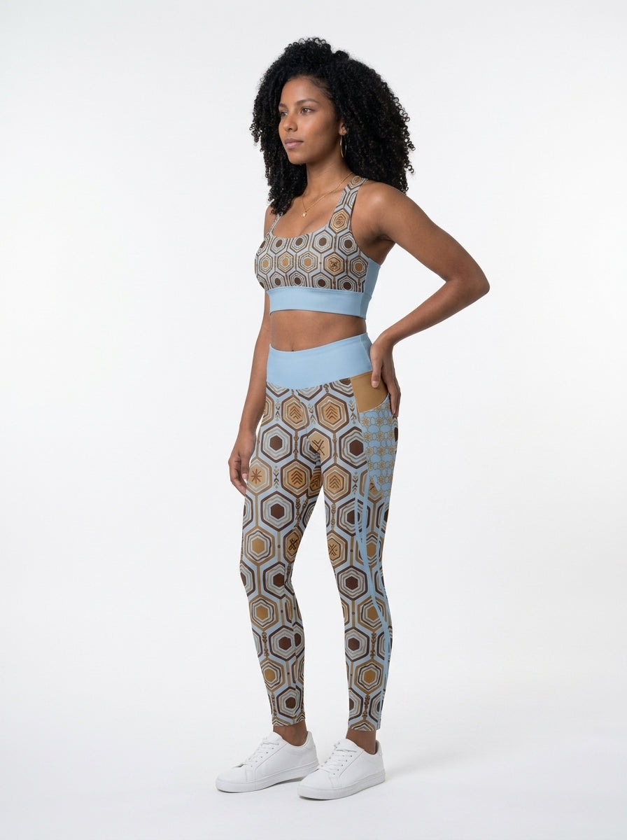 AnanseNova™ Set // Bra + Pocket Leggings in Igwe Blue — three-quarter left view on model, matching longline bra and pocket leggings