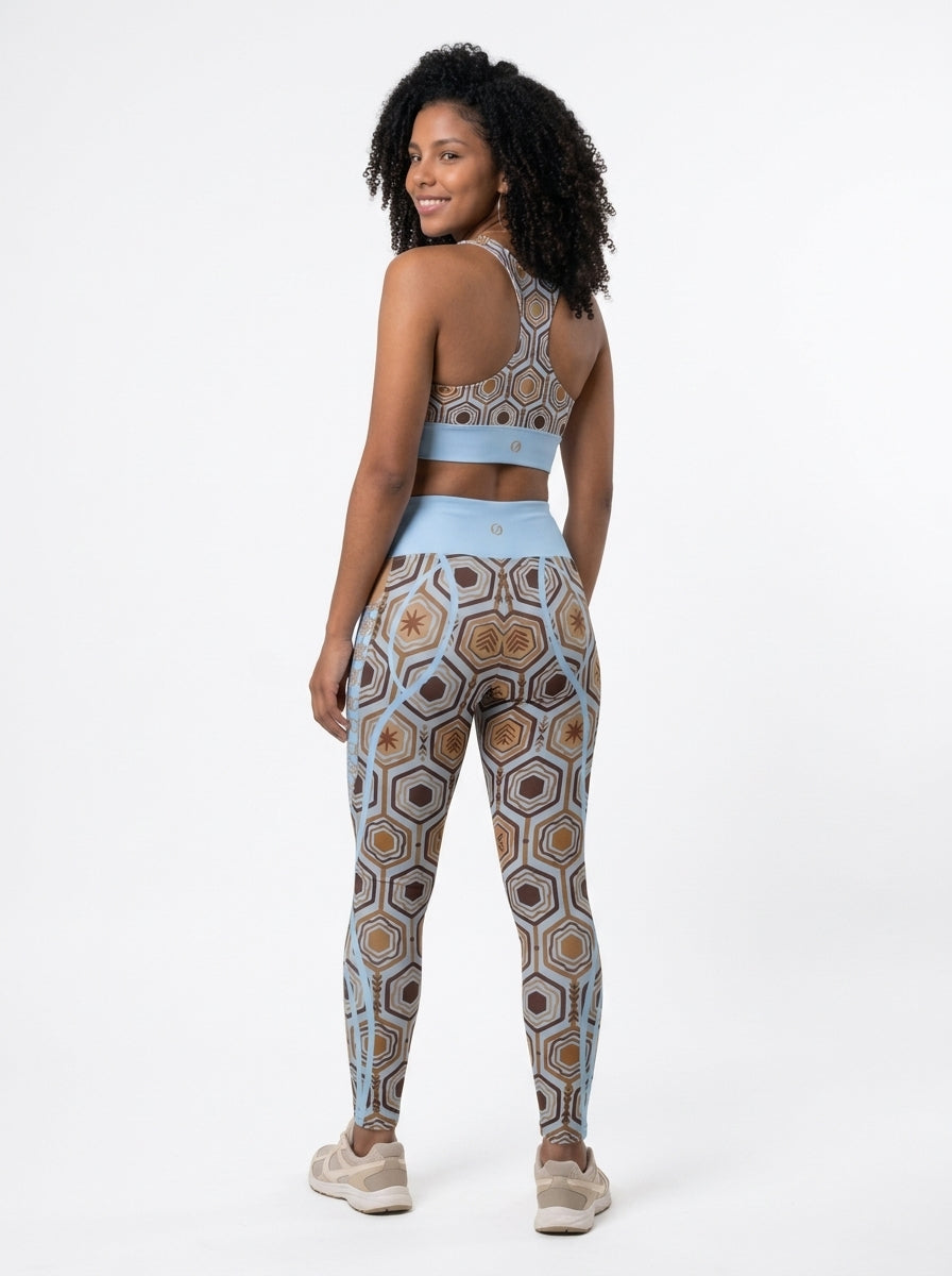 AnanseNova™ Set // Bra + Pocket Leggings in Igwe Blue — back view on model, racerback bra and leggings back waistband with SunBorn crest