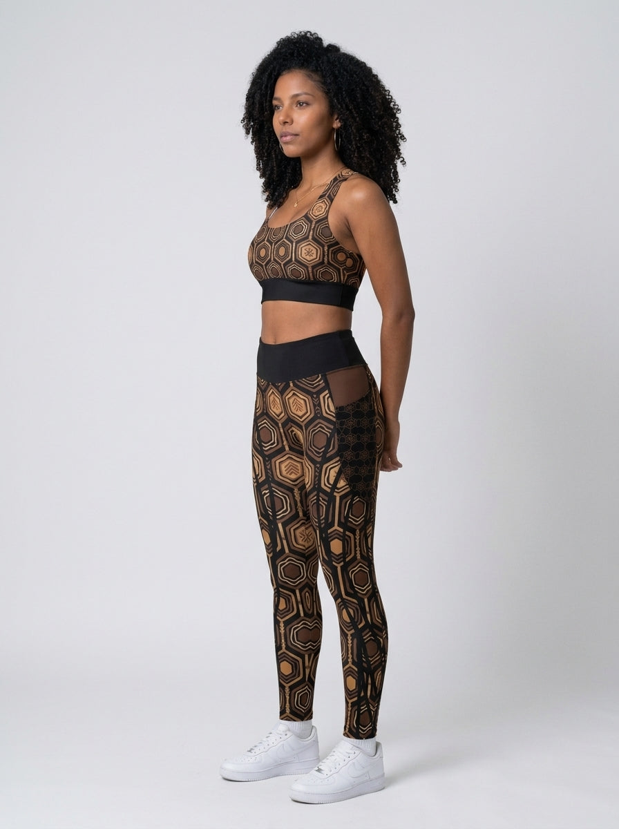 AnanseNova™ Set // Bra + Pocket Leggings in Oji Black — three-quarter left view on model, matching longline bra and pocket leggings