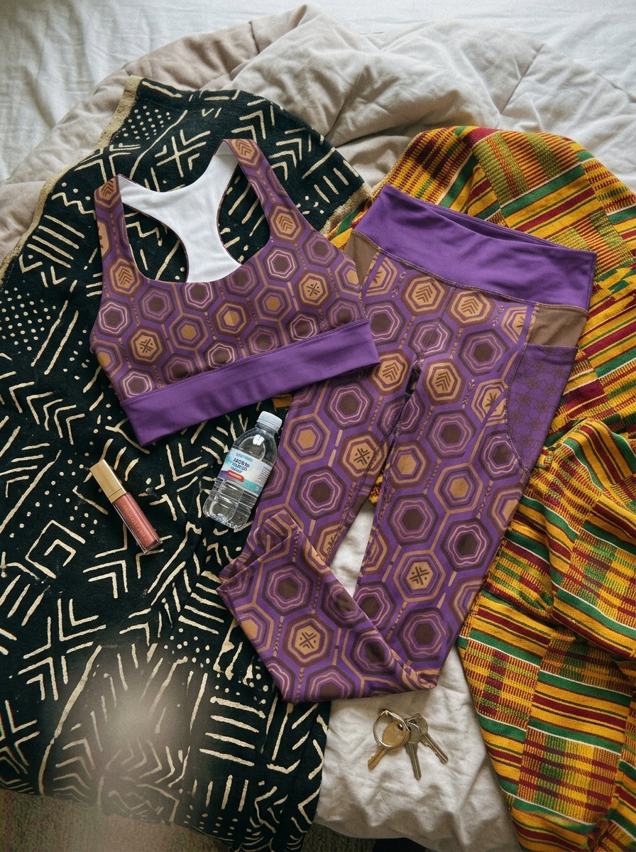 AnanseNova™ Set // Bra + Pocket Leggings in Ugo Purple — styled flat lay of the matching bra and pocket leggings with kente and mudcloth textiles