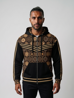 AnanseNova™ Zip Hoodie in Oji Black, front view on model — hexagon all-over print, bronze chevron stripes, full zip