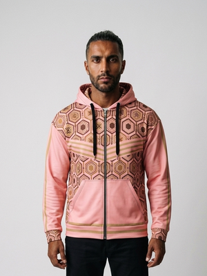 AnanseNova™ Zip Hoodie in Eze Pink, front view on model — hexagon all-over print, bronze chevron stripes, full zip