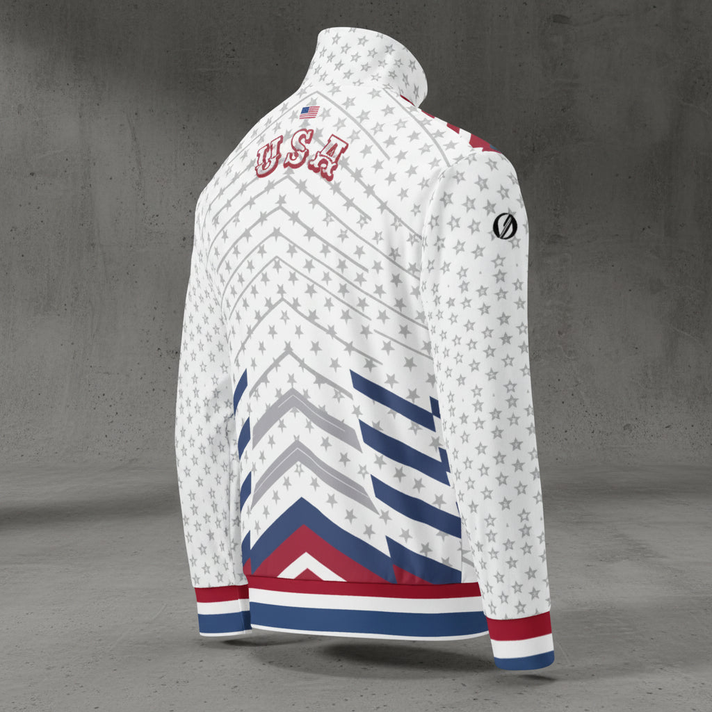 USA '26 Track Jacket — three-quarter right-back view showing the inverted chevron geometry, varsity USA wordmark, sublimated grey star-field across the chassis