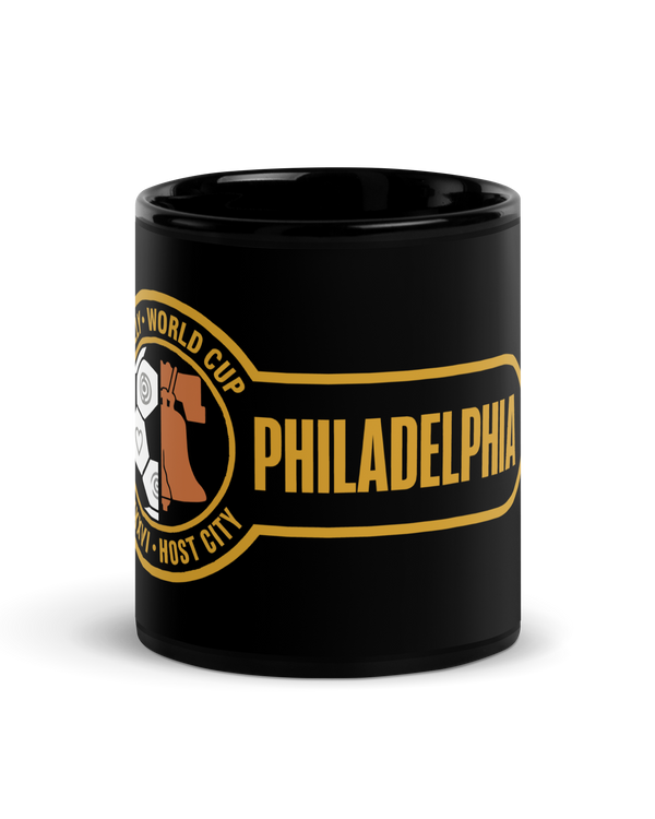 Liberty Protocol Philly '26 Mug — Black Glossy 11oz, front view of Liberty Bell and soccer ball crest